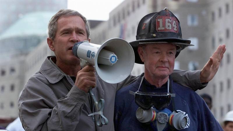 President George W. Bush, left, stands next to retired New York Fire Department firefighter Bob Beckwith on September 14, 2001, three days after the 9/11 terror attacks.