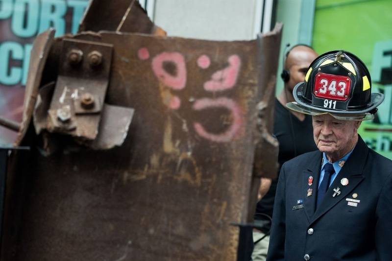 Bob Beckwith stands next to a piece of steel from the World Trade Center during a 2016 ceremony as the memento heads from New York City to Gander, Newfoundland.