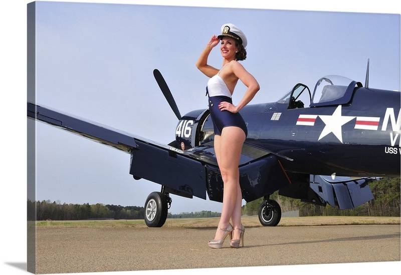 1940s-style-navy-pin-up-girl-posing-with-a-vintage-corsair-aircraft,2009979.jpg