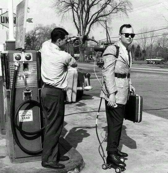 A salesman has his motorized roller skates refueled. Connecticut, 1961.jpg