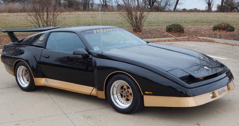Black and gold 1985-1991 Pontiac Tojan in a Parking Lot