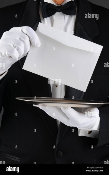 closeup-of-a-butler-wearing-a-tuxedo-holding-a-silver-tray-and-an-D04DX0.jpg