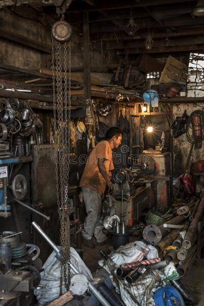 indonesian-worker-operates-his-machine-old-worshop-jakarta-indonesia-workshop-136337179.jpg