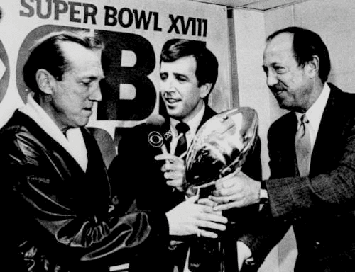 Oakland Raiders AFL 1984 Al Davis accepting Super Bowl Trophy # XVIII  Comissioner Pete Rozelle.png