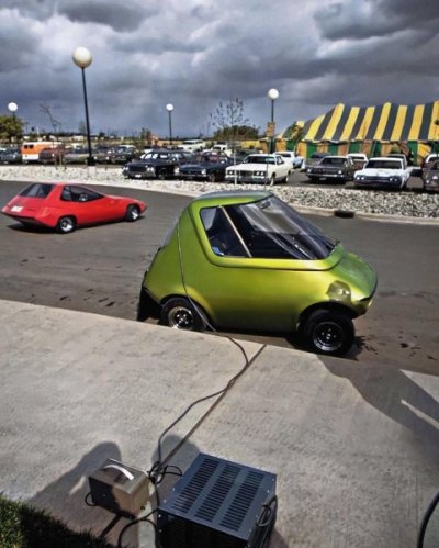 A General Motors urban electric car gets a battery charge. In the background is the EBS electr...jpg