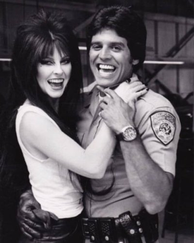 0000 56 Elvira and Erik Estrada on the set of CHIP's.jpg