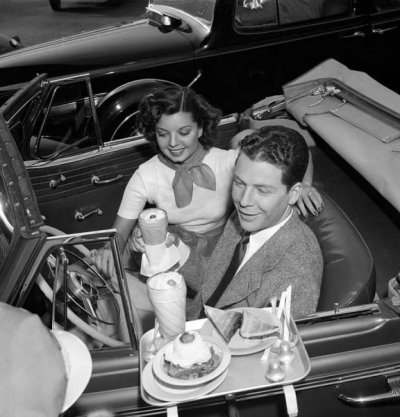 Frances Langford and Kenny Baker take a snack break at a drive-in cafe 1939.jpg