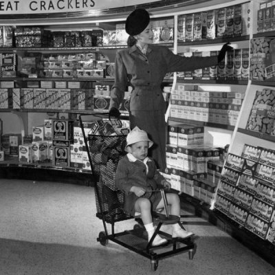 woman-smiles-as-she-takes-a-box-of-crackers-from-the-shelf-news-photo-1612532324.jpeg