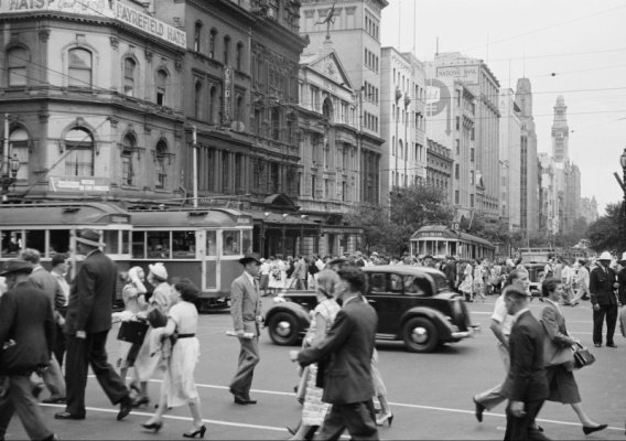 commuters_walk_past_cars_and_trams_in_a_melbourne_street_in_the_1950s_1.jpeg