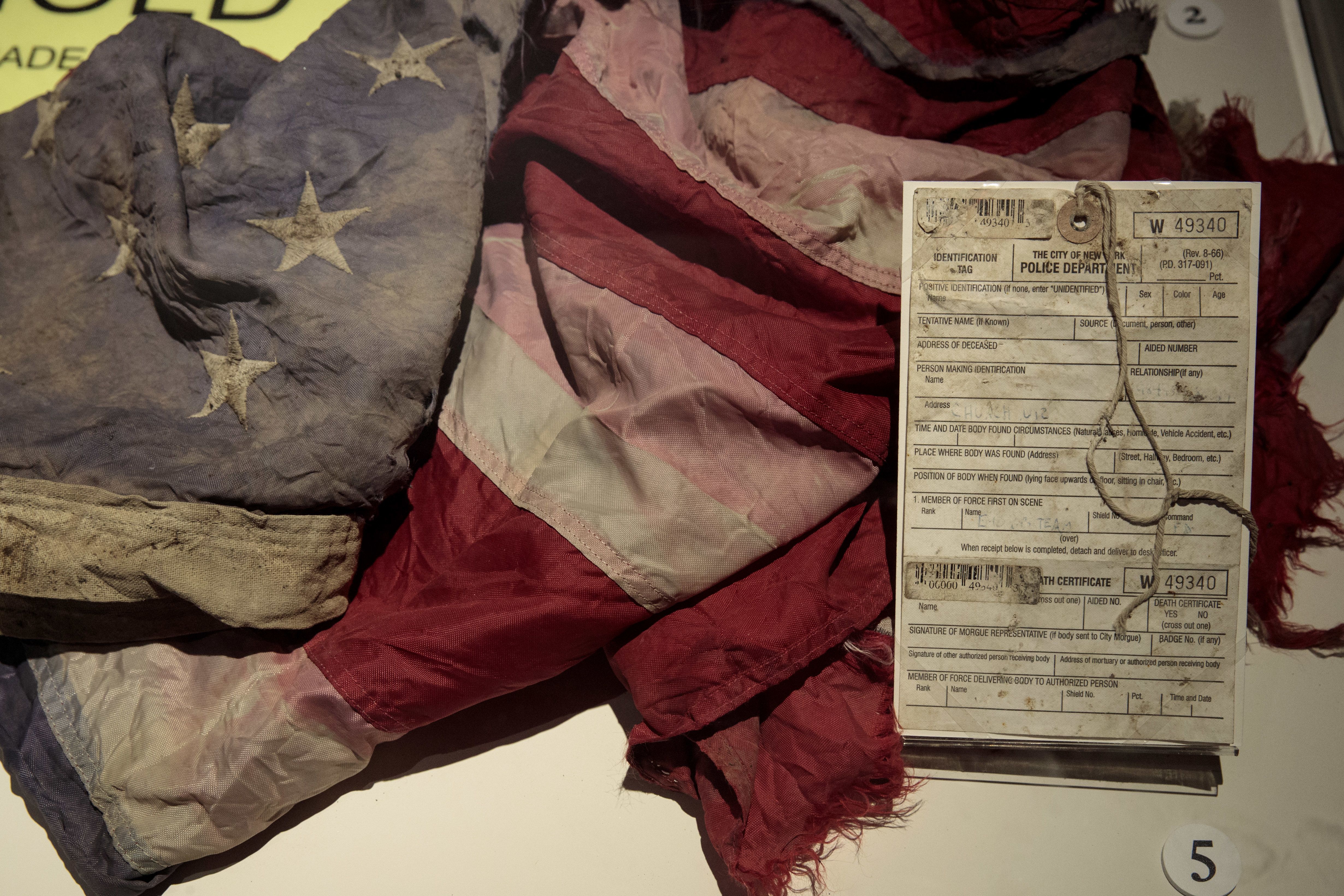 NEW YORK, NY - JUNE 13:  A New York City Police Department death certificate and an American flag recovered at Ground Zero are displayed at new 9/11 Tribute Museum, June 13, 2017 in New York City. The new 9/11 Tribute Museum is officially opening today in an expanded location. The museum shares the personal stories of those directly impacted by the September 11, 2001 terrorist attacks on the World Trade Center. (Photo by Drew Angerer/Getty Images)